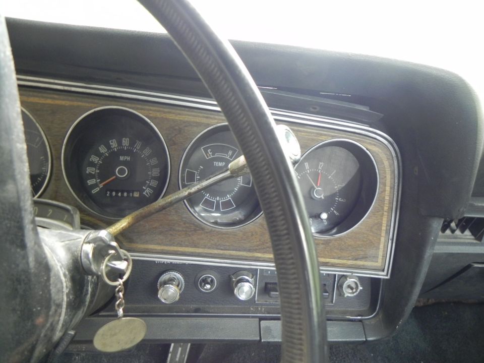 1974 Ford Ranchero interior dashboard with speedometer, temperature gauge, and clock