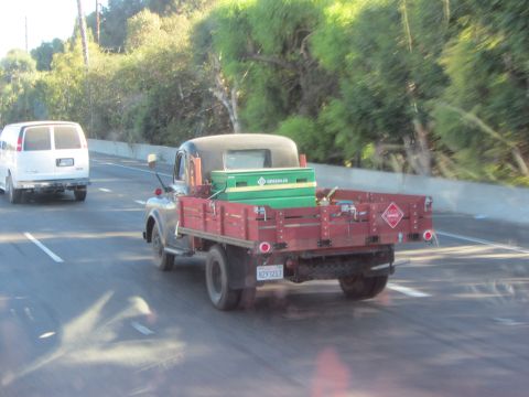 1968 Ford Mustang - Flatbed truck with a green toolbox is seen on the highway.