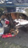 1979 Ford Bronco - The rear axle and suspension components of a vehicle are shown during a repair or maintenance procedure.