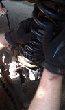 1979 Ford Bronco - Close-up of suspension components during repair work.