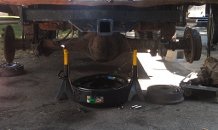 1979 Ford Bronco - Underside view of a vehicle's rear axle assembly, likely undergoing maintenance or repair work.