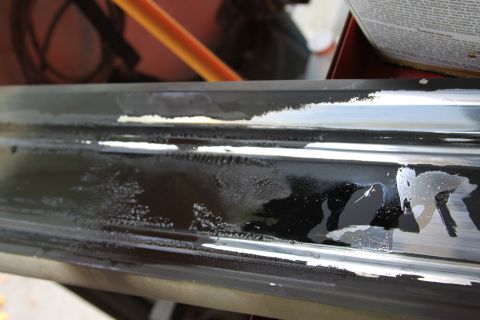 1979 Ford F-350 - Close-up of a damaged black interior door panel showing peeling paint and water marks.