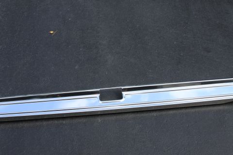 1979 Ford F-350 - Close-up of a chrome trim piece with a black insert, possibly a vehicle exterior part.