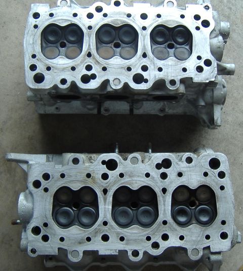 1995 Ford Probe - Two engine cylinder heads with visible valves are laid out on a surface.