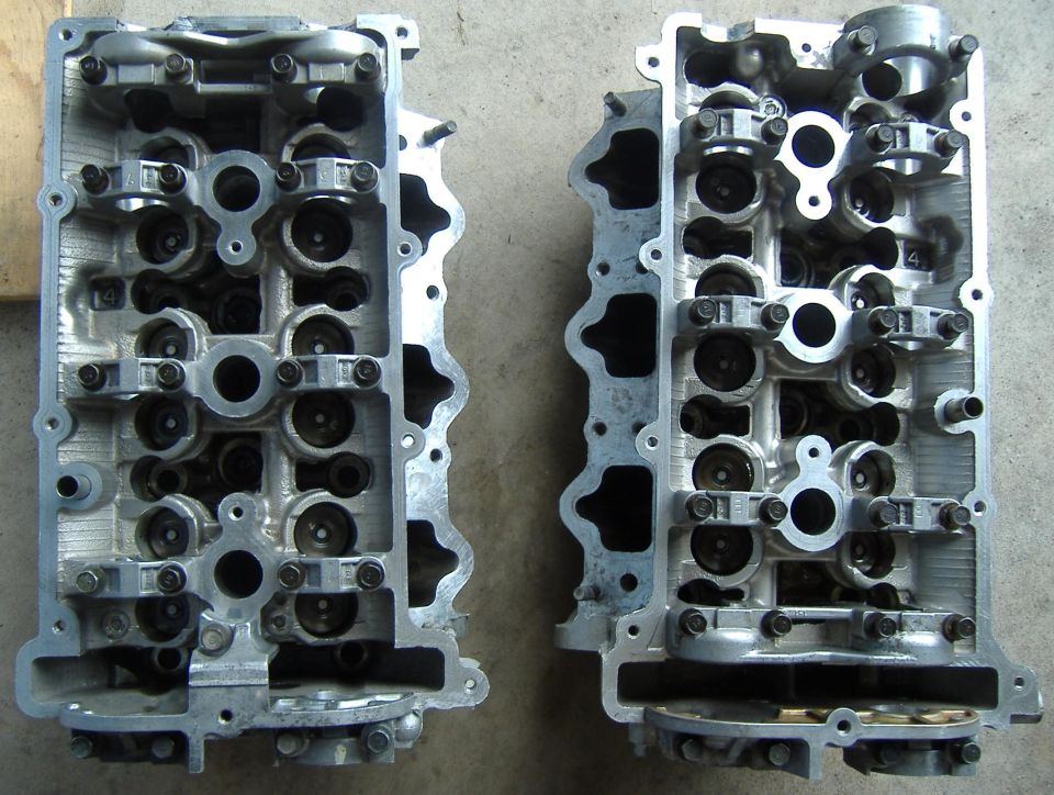 Two engine cylinder heads, one on the left and one on the right