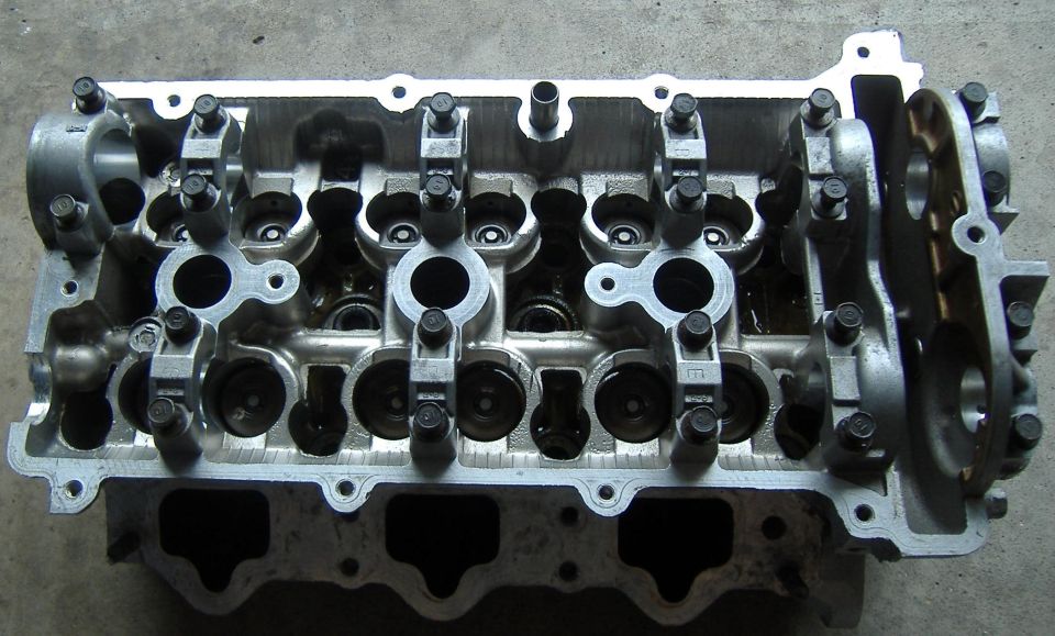 Aluminum engine cylinder head with visible valves and rocker arms