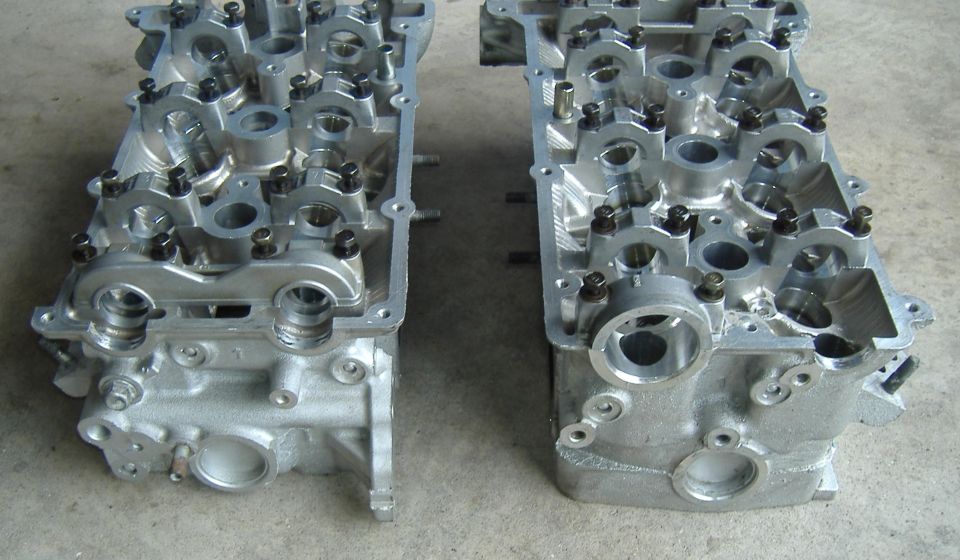 Two aluminum engine cylinder heads side-by-side