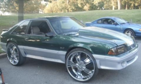 2007 Ford Mustang - A modified Ford Mustang from the late 1980s is parked outside, with another vehicle in the background.