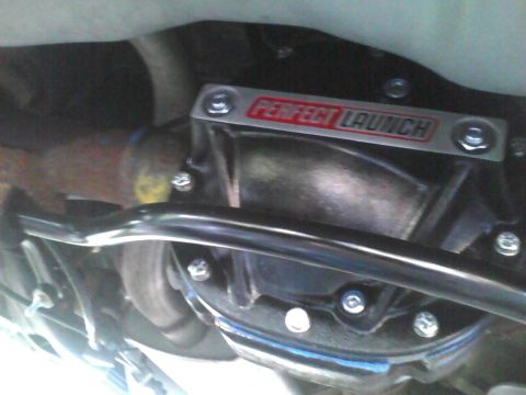 2003 Ford Crown Victoria - Aftermarket 'PERFECT LAUNCH' cover on a rear differential assembly, likely an upgrade part.