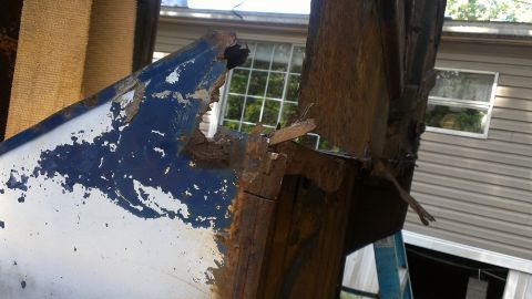 1978 Ford Bronco - Close-up of heavily corroded metal with peeling paint, showing significant rust damage.