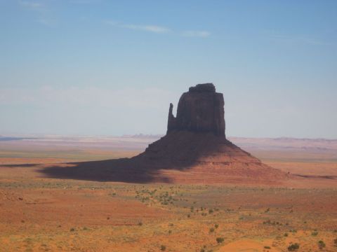 1991 Ford LTD Crown Victoria - Monument Valley landscape with a prominent rock formation and desert terrain under a clear sky.