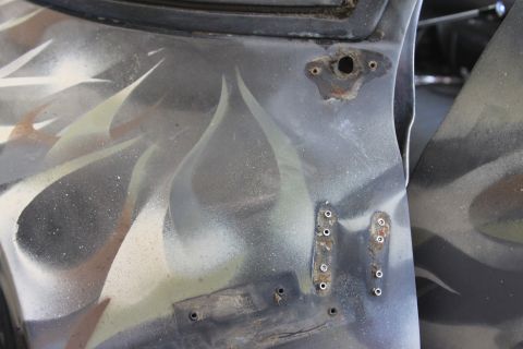 1979 Ford F-350 - Close-up of a truck door section custom flame graphics and visible mounting points.