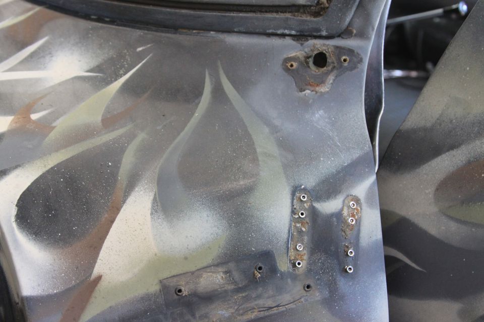 Truck door part with flame graphics and mounting holes