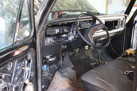1979 Ford F-350 - The interior of a 1979 Ford F-350 is shown with the dashboard and door panels removed for disassembly.