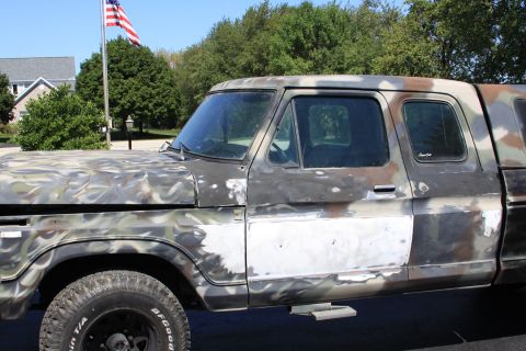 1979 Ford F-350 - This pickup truck is undergoing repairs and has a camouflage paint job with visible body filler.