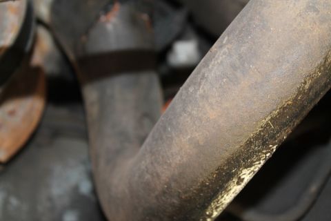 1990 Ford Bronco - This is a close-up view of an exhaust pipe, showing signs of rust and grime.