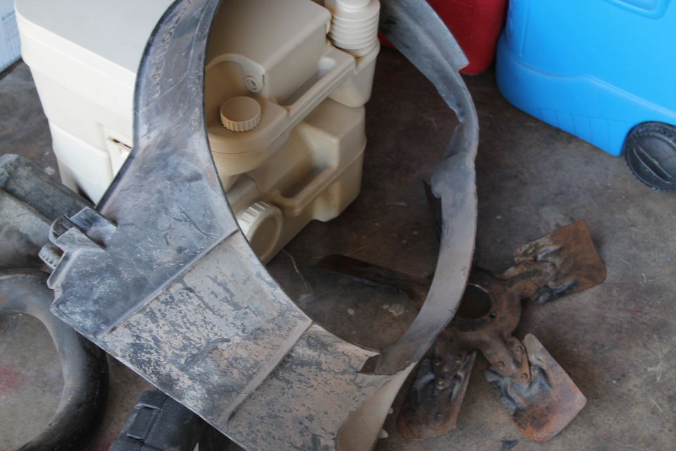 Plastic shroud and a beige water jug on the ground