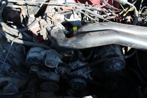 1990 Ford Bronco - Close-up view of an engine bay, showing various components and hoses.
