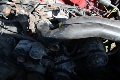 1990 Ford Bronco - Engine bay detail with hoses and belts visible.