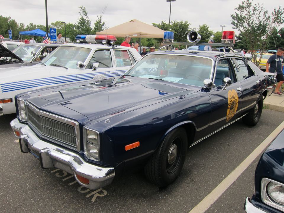 Dark blue state police Plymouth sedan with roof light bar and speaker at a show
