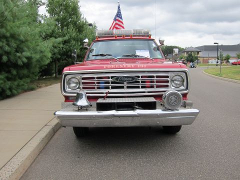 1991 Ford LTD Crown Victoria - Head-on front view of a red forestry fire truck with a Pierce grille badge, chrome bumper, roof lights and a U.S. flag.