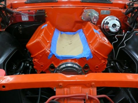 1968 Chevrolet Camaro - Engine bay during restoration, showing a freshly painted V8 engine block with masking tape.