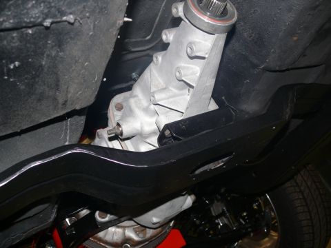 1968 Chevrolet Camaro - Close-up of a vehicle's transmission and frame components, viewed from below.