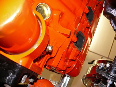 1968 Chevrolet Camaro - Orange engine block detail with exhaust ports visible.