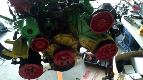 1987 Ford Bronco - Engine parts painted in bright colors with visible belts and pulleys.