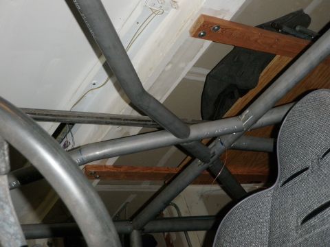 1961 International Scout 800 - Metal roll cage tubing and a racing seat are shown in this close-up view.