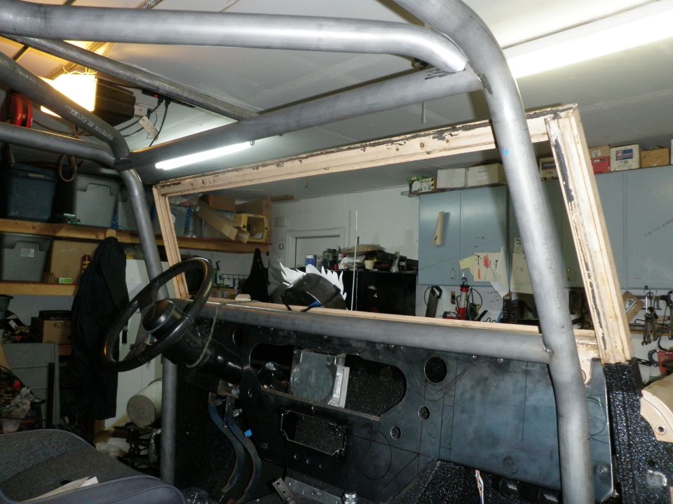 Vehicle interior with a metal roll cage, dashboard, and steering wheel
