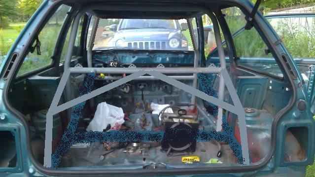 Interior view of a car stripped down with a roll cage installed. Another SUV is visible through the rear window