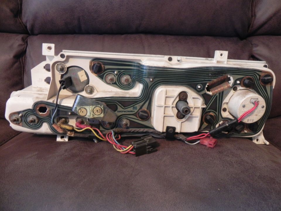 Back of a car's instrument cluster with wiring and circuit board visible