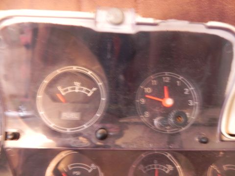 1974 Ford Ranchero - The dashboard features a fuel gauge and a clock, indicating the vehicle's current fuel level and time.
