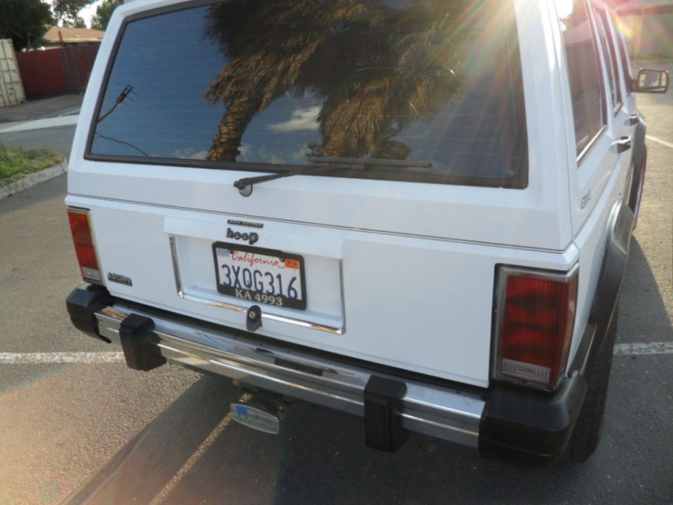 rear view of white Jeep Cherokee with California plates