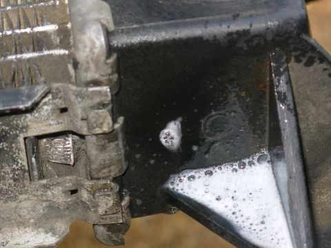 1983 Ford Bronco - With the radiator removed, ports plugged, and Windex on the tank, the leak is apparent, even at 7psi. GO TO THE NEXT PIC...