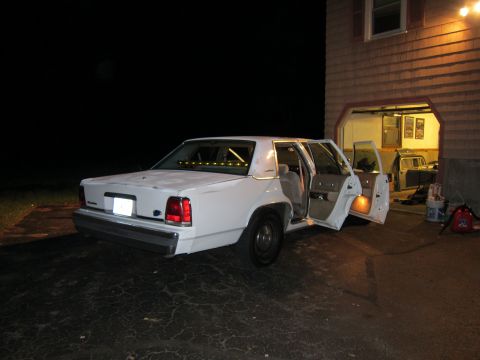 1991 Ford LTD Crown Victoria - This 1991 Ford Crown Victoria LTD is seen with its rear doors open, parked in a driveway at night.