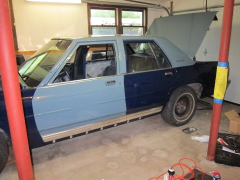 1991 Ford LTD Crown Victoria - This 1991 Ford Crown Victoria LTD is in a garage, showing two-tone paint and open hood/trunk.