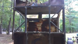 1978 Ford Bronco - This heavily rusted vehicle cab appears to be part of a project, with a roll cage structure added. Another vehicle is visible in the backgr…