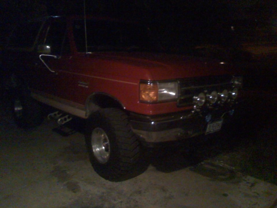 Red pickup truck with off-road lights, 3/4 front view