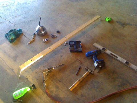 1990 Ford Bronco - Tools and materials laid out on a concrete floor, possibly for a DIY project.