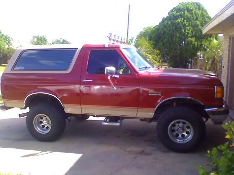 1990 Ford Bronco - This red 1990 Ford Bronco features a two-tone paint scheme with a tan removable top.