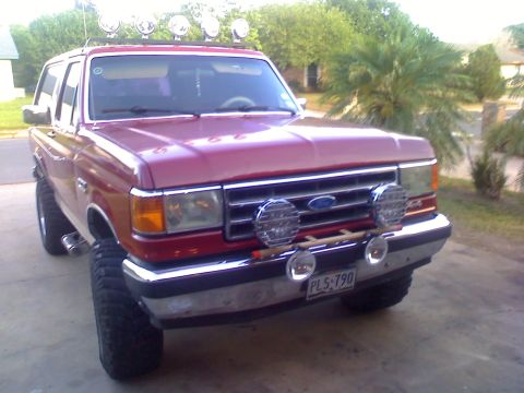 1990 Ford Bronco - This red 1990 Ford Bronco is equipped with roof-mounted lights and front fog lamps.