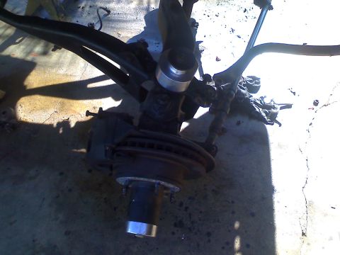 1990 Ford Bronco - This image shows a disassembled vehicle suspension component, including the brake rotor and hub assembly.