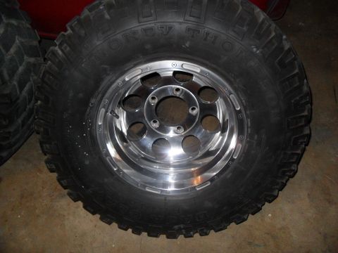 1990 Ford Bronco - A close-up of a tire and wheel assembly, showing the tread pattern and rim details.