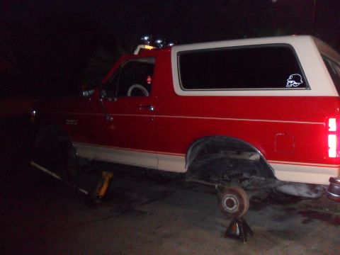 1990 Ford Bronco - This 1990 Ford Bronco is shown in profile, elevated on jack stands with its rear wheel removed.