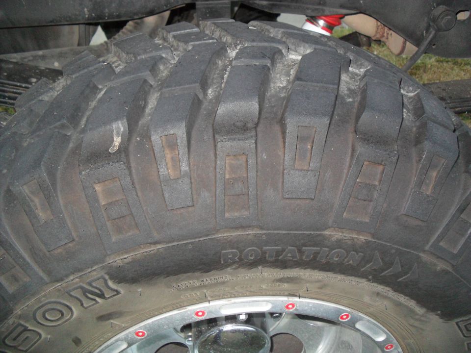 Close-up of a large off-road tire with 'ROTATION' visible on sidewall