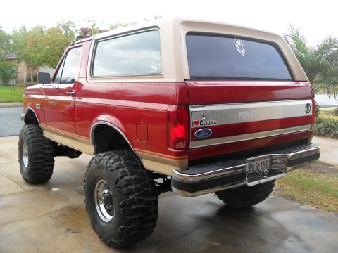 1990 Ford Bronco - This 1990 Ford Bronco features a lifted suspension and oversized tires, indicating off-road capability.