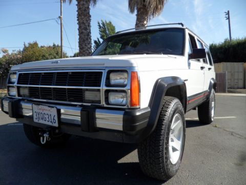 1994 Jeep Cherokee - This 1994 Jeep Cherokee is shown from a 3/4 front view, parked on asphalt.
