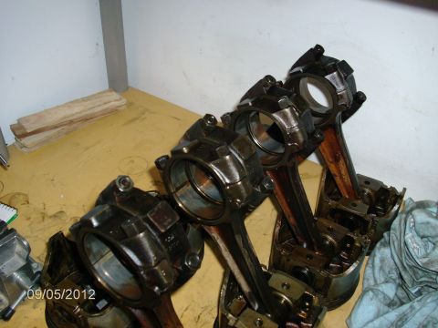 1979 Ford F-150 - Several engine pistons and connecting rods are visible in this close-up shot.